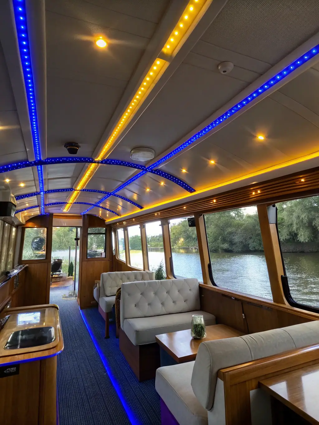 A photo of a modernized narrowboat interior, blending traditional design with contemporary amenities such as updated electrical systems.